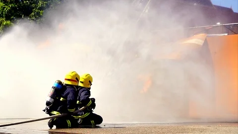 Slow motion shot of firefighter in fire suit on safety rescue duty Stock Footage 120660889