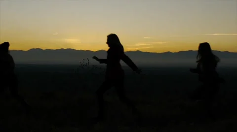 Slow Motion Shot Of Five Pretty Teens Running Across A Tranquil Scene At Dusk Video stock 34287469