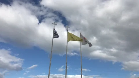 Slow Motion Shot of Flags Waving vs Cloudy Sky out of Greek Church in Cyprus Stock Footage 100678907