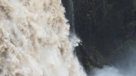 Slow Motion shot of Flooded Waterfall Plunging into Canyon Stock Footage 124664268