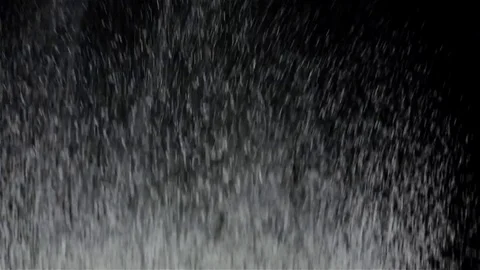 Slow motion shot of flour sifting against black background, closeup Stock Footage 75487212