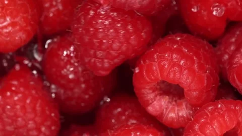 Slow motion shot of flying and splashing ripe raspberries and water drops o.. Stock Footage 313611087