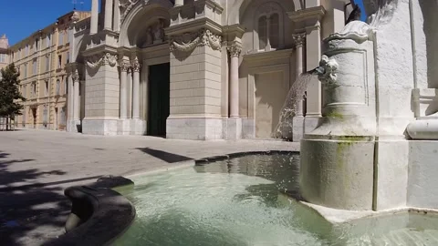Slow Motion Shot of a Fountain while a Bird is Drinking Stock Footage 229211142