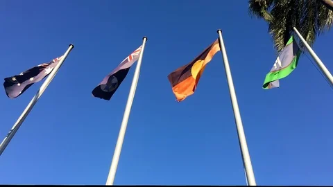 Slow motion shot of the four flags outside Queensland Parliament House Stock Footage 110838984