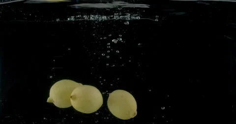 Slow-motion shot of a fresh Lemon being thrown into water. Stock Footage 300502397