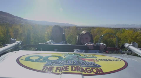 Slow motion shot of front seat of rollercoaster. Couple is screaming. Stock Footage 52263806