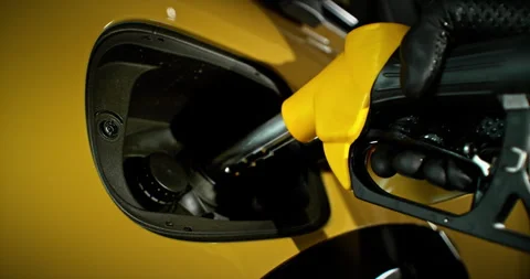Slow motion shot of fuel nozzle inserting into car tank, static camera. Stock Footage 332909477