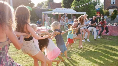Slow Motion Shot Of Game Of Tug Of War At Summer Garden Fete Stock Footage