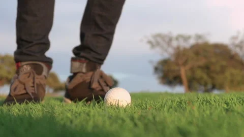 Slow motion shot of a golf ball being hit by a golfer swinging Stock Footage 167859867