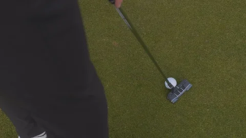 Slow Motion shot of golfer hitting putt Stock Footage 104563837