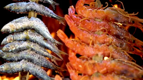 SLOW MOTION shot of grilling fish on the barbecue mesh grill. Stock Footage 135270971