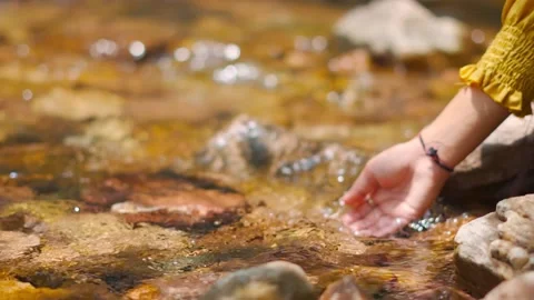 Slow motion shot of hand touching water in the river or lake. Autumn forest rive Stock Footage 208951039