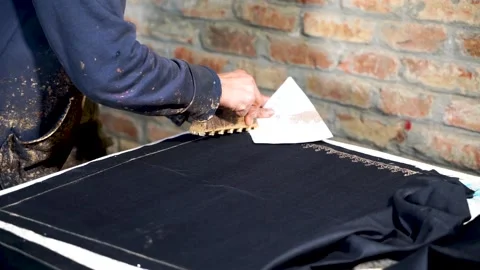 Slow motion shot of handmade block printing on black fabric with gold color  Stock Footage 199272585