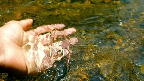 Slow motion shot of hands and arms in the stream. Stream water flowing on han Stock Footage 270319396