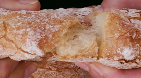 Slow motion shot of hands breaking a loaf of homemade bread Stock Footage 67618177