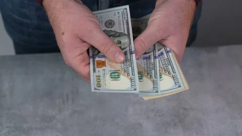 Slow motion shot. Hands counting US Dollar bills or paying in cash on money Video stock 169640955