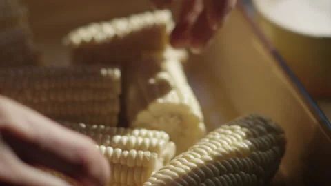 Slow motion shot of hands splitting corn in two Video stock 153300468