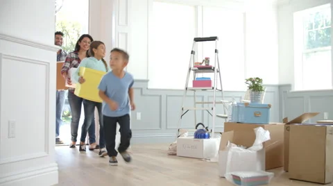 Slow Motion Shot Of Hispanic Family Moving Into New Home Stock Footage
