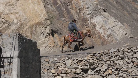 Slow motion shot of horse rider entering Mustang restricted area. Stock Footage 127928362