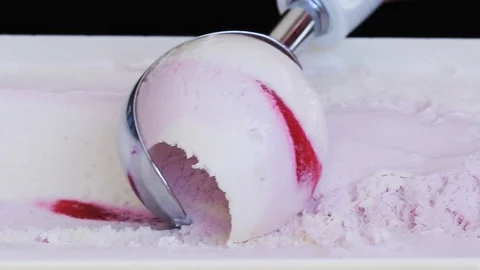 Slow motion shot of ice cream being scooped with an ice cream scoop Stock Footage