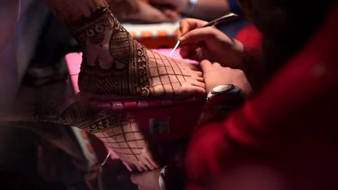 A Slow Motion Shot of an Indian Bride applying mehendi on her feet Stock Footage 277187777
