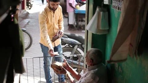 Slow motion shot of Indian old age vender selling coconut at street shop. Stock Footage 240736290