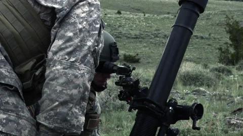 Slow motion shot of instructor overseeing soldier aiming mortar launcher. Stock Footage 52257428