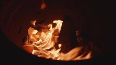 Slow motion shot of joss paper money being burnt Stock Footage 88850837