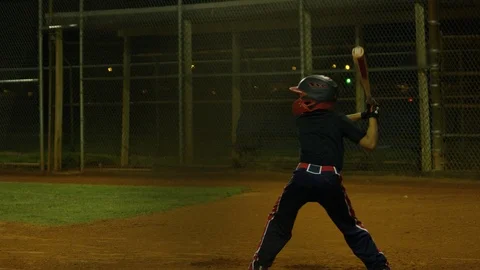 Slow motion shot of a kid batting a ball during baseball practice Stock Footage 106273492