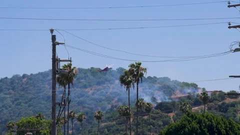 Slow motion shot of LAFD responding to wildfire with aerial unit Stock Footage 335974731