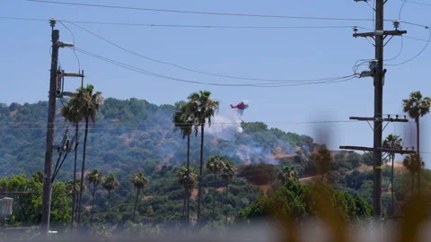 Slow motion shot of LAFD responding to wildfire with aerial unit Stock Footage 335975017