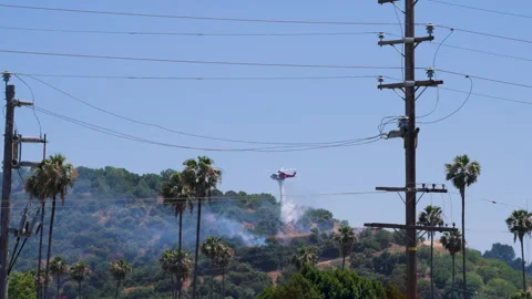 Slow motion shot of LAFD responding to wildfire with aerial unit Stock Footage 335975110