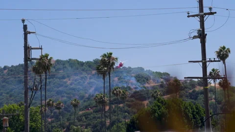 Slow motion shot of LAFD responding to wildfire with aerial unit Stock Footage 335975492
