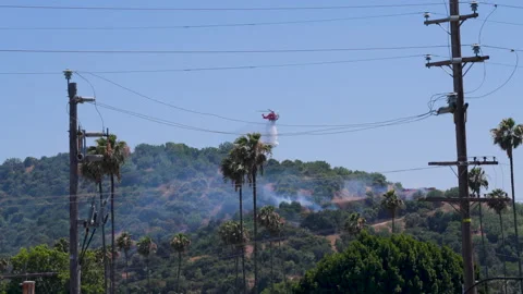 Slow motion shot of LAFD responding to wildfire with aerial unit Stock Footage 335975912