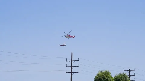 Slow motion shot of LAFD responding to wildfire with aerial unit Stock Footage 335976012