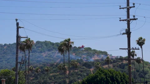 Slow motion shot of LAFD responding to wildfire with aerial unit Stock Footage 335976166