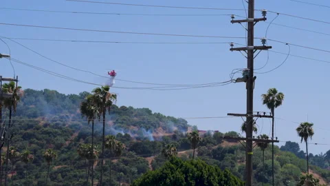 Slow motion shot of LAFD responding to wildfire with aerial unit Stock Footage 335976248
