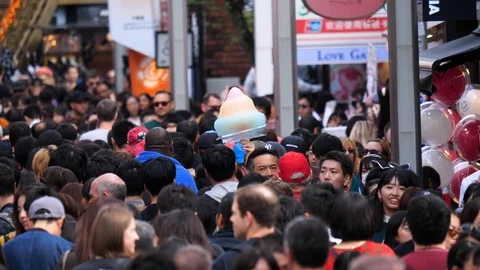 Slow motion shot of a large group of people, walking on the crowded Stock Footage 124629402