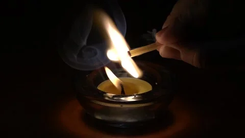 Slow motion shot of lighting a match on a burning candle flame Stock Footage 230323655