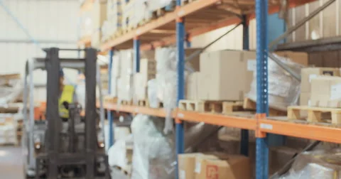 Slow motion shot of a Logistics man getting off a forklift and inspecting items Video stock 65040815