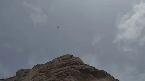 Slow Motion Shot Looking up at Sandstone Cliff and Blue Sky with Seagulls Stock Footage 70791500