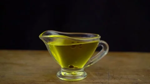Slow motion shot of making sauce from olive oil and balsamic vinegar on black Stock Footage 134313399