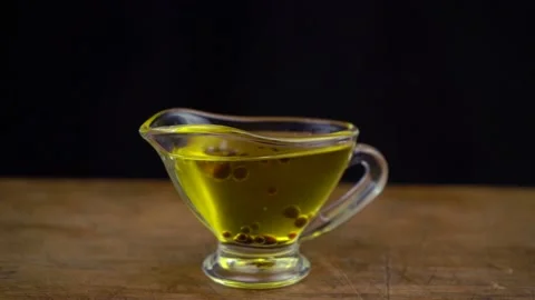 Slow motion shot of making sauce from olive oil and balsamic vinegar on black Stock Footage 134313492