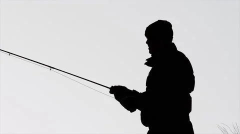 Slow motion shot of a man fly fishing in a river, silohuetted against the sky Video stock 44008228