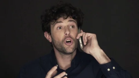 Slow motion shot of man having stressful phone call on cell phone Stock Footage 75169488