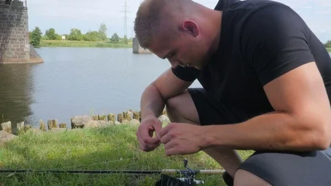 Slow motion shot of a man preparing reel before fishing Video stock 84004006
