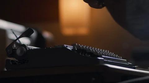 Slow motion shot of a man putting paper in an old vintage typewriter Stock Footage 97873550