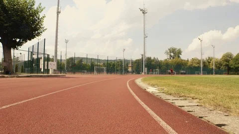 Slow motion shot of a man on a running track in the park Stock Footage