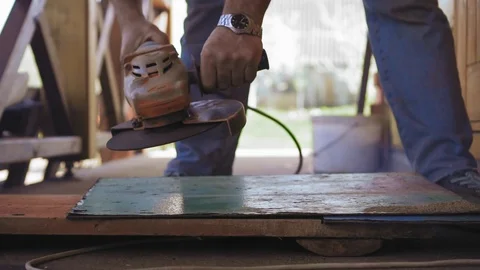 Slow motion shot of man is using an electric saw at a construction site. Sparks Stock Footage 90428324