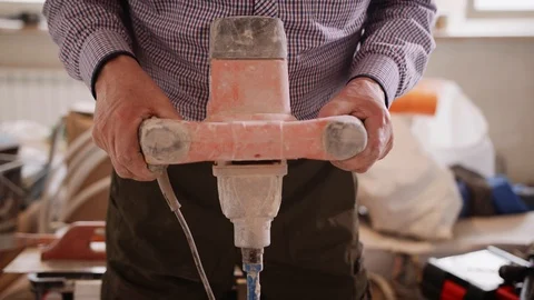 Slow motion shot of a man using rotating electric hand mixer to mix the cement Stock Footage 125623455